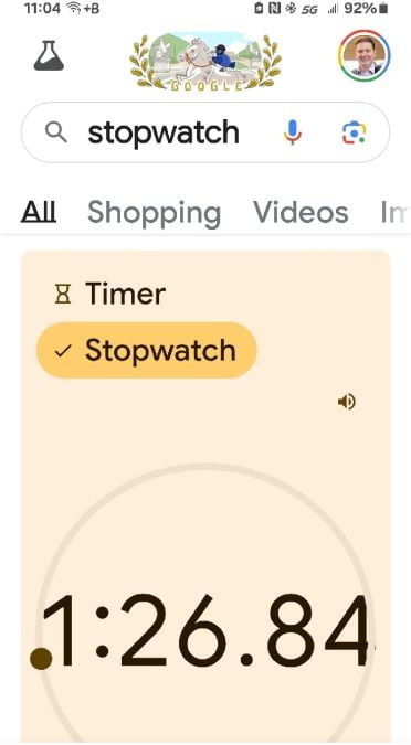 Image of a stopwatch timing a hybrid car fuel-up