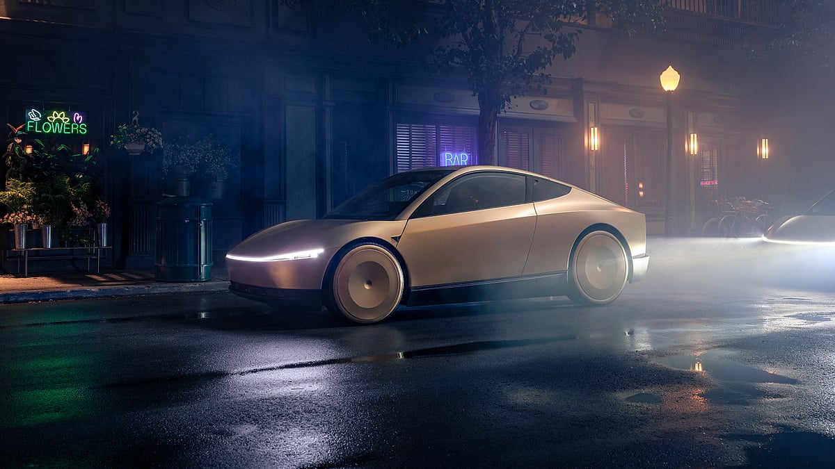 Tesla Cybercab shown in side profile on a wet city street at night with neon storefront lights.