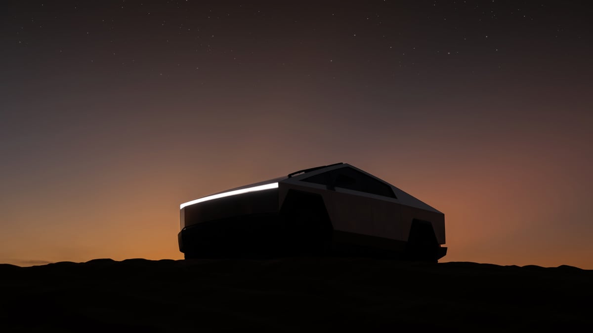 Tesla Cybertruck silhouetted in the desert at night beneath a starry sky and orange sunset