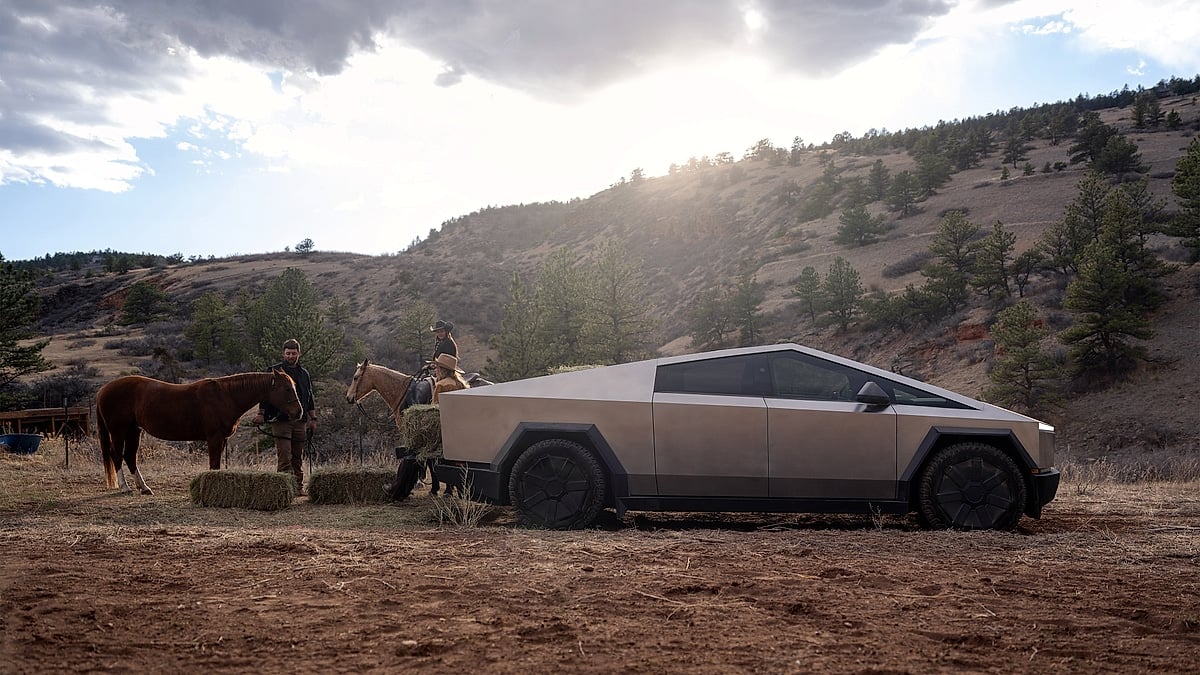 Tesla Cybertruck parked at ranch with horses and people showing real-world utility and lifestyle use of electric pickup