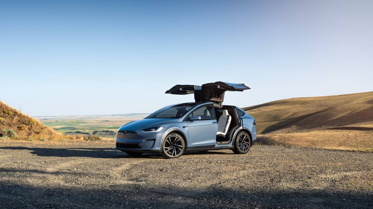 Blue Tesla Model X front three-quarter view displaying sleek electric SUV styling and aerodynamic profile