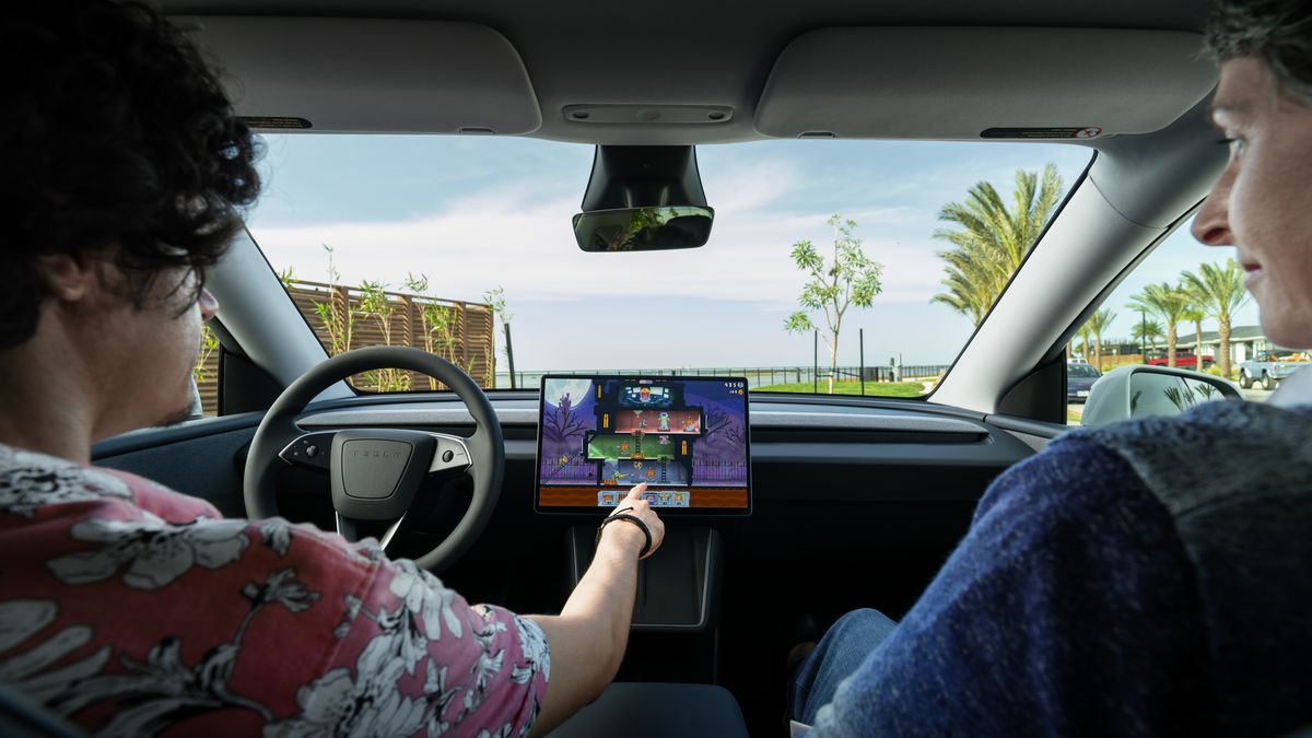 Tesla Model Y interior with center touchscreen displaying in-car gaming on minimalist dashboard