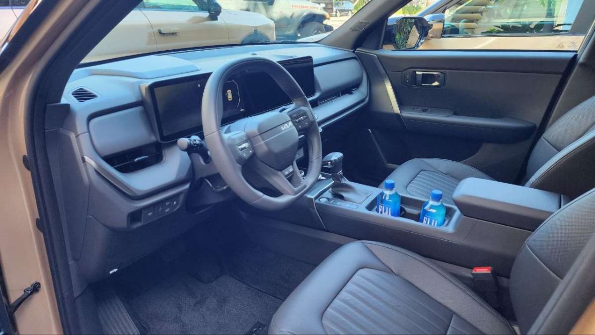 The front interior and the infotainment screen of the 2027 Kia Seltos