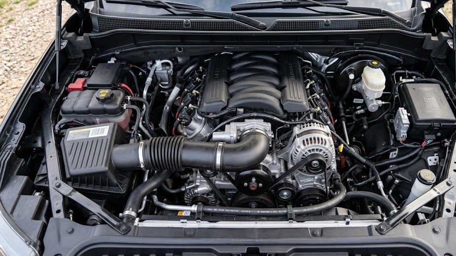 Top-down photograph of the clean, well-lit GM 6.2L V8 EcoTec3 engine bay, emphasizing its intricate mechanical structure