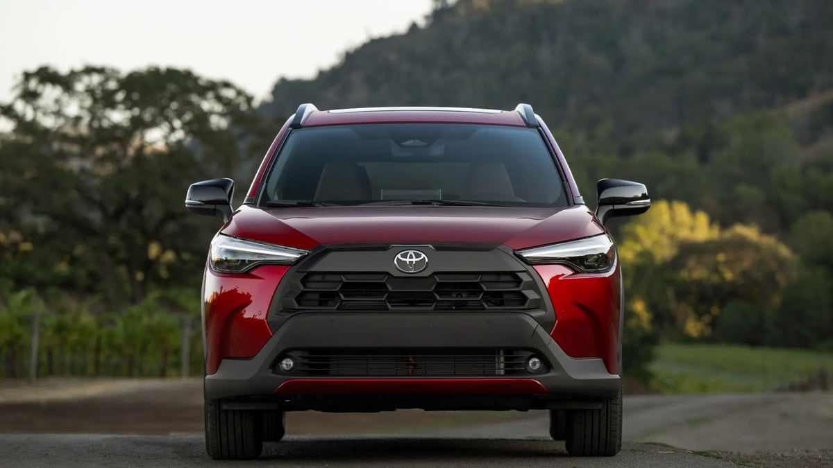 2026 Toyota Corolla Cross XLE AWD in Soul Red Crystal metallic paint with LED headlights and distinctive grille, front three-quarter view