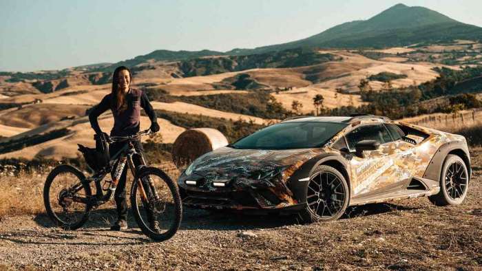 The Lamborghini Huracan Sterrato is pictured parked beside the mountain biker it races in the new &quot;Beyond the Concrete&quot; teaser video.