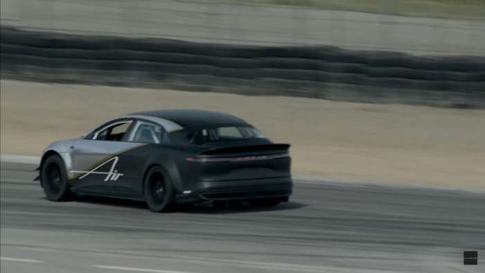 Image of a prototype tri-motor Lucid Air testing at Laguna Seca with a black and chrome wrap.