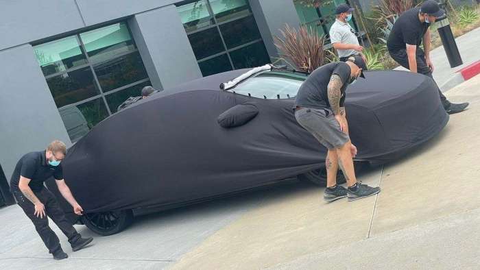 Image showing the Lucid Air Sapphire under a cover as it heads to The Quail for its reveal