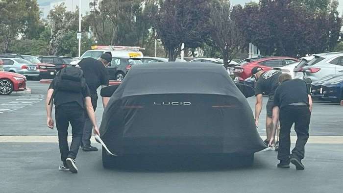 Image showing the Lucid Air Sapphire under a cover as it heads to The Quail for its reveal