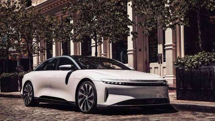 Image of a white Lucid Air Grand Touring parked outside a restaurant.