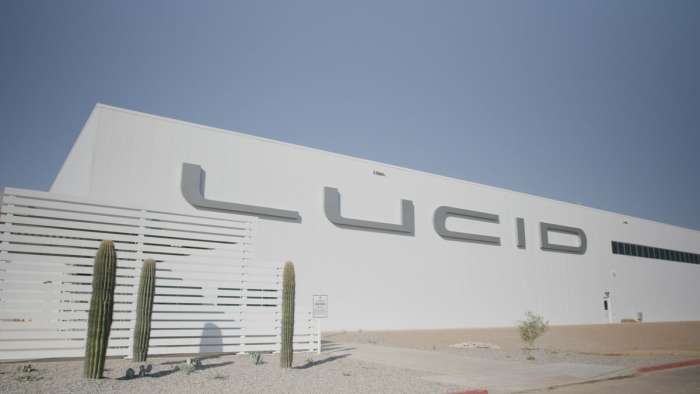 Image of the Lucid logo on the AMP-1 factory in Arizona with blue skies overhead.