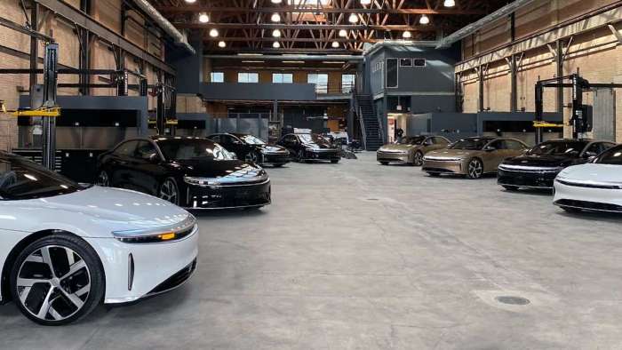 Image of eight Lucid Airs parked in a Lucid facility in Chicago awaiting delivery to or pickup by their new owners.