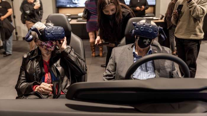 Image showing two Lucid customers using the VR system at a Lucid Studio to design their new Air sedan.
