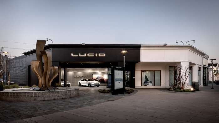 Image showing the new Lucid Studio in Corte Madera, California which a white Lucid Air parked inside.