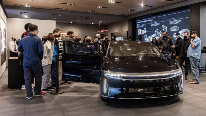 Customers explore a Lucid Air EV sedan at the new Lucid Studio in the Washington, D.C. Metro Area