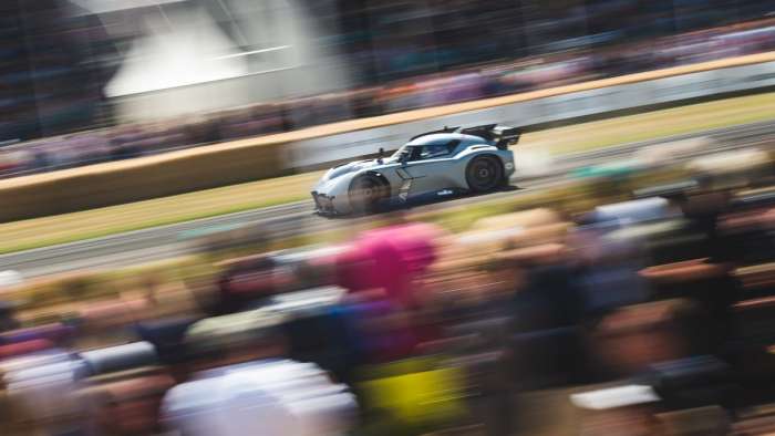 Image of the McMurtry Speirling on track as it streaks past spectators.