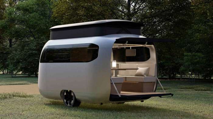 Image of the Porsche Airstream Concept Travel Trailer parked up with its rear hatch open and it's pop-up roof extended.