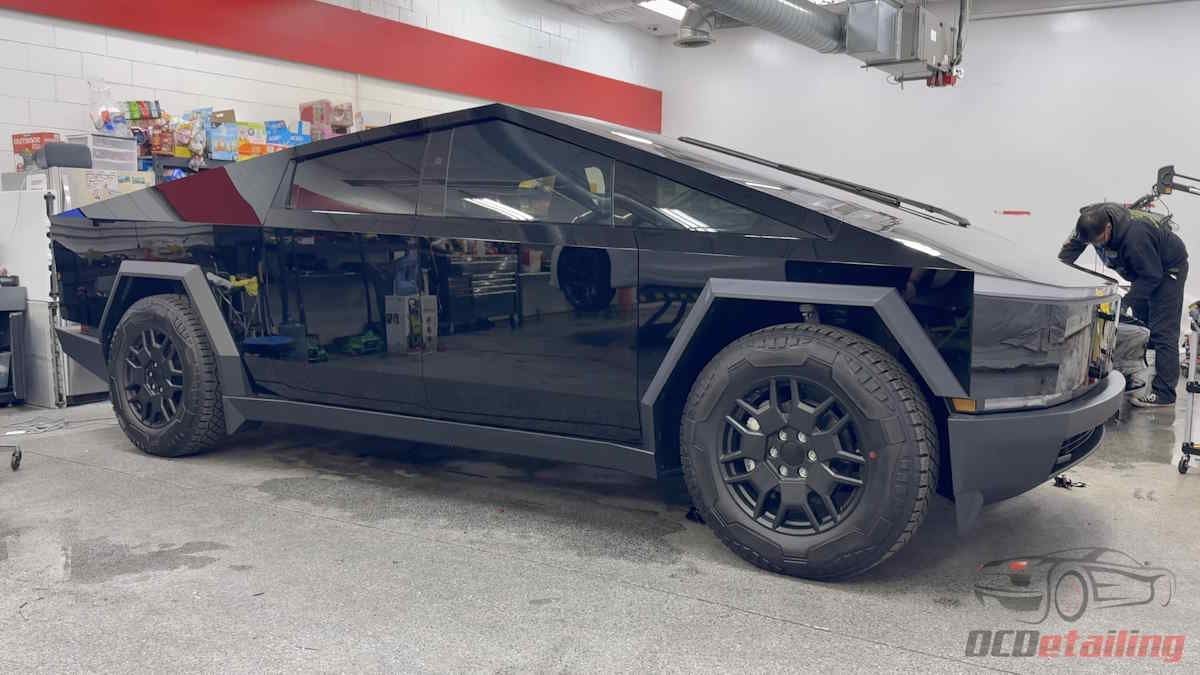 Tesla Cybertruck Seen Being Detailed In Shop Without Side Mirrors - In Gloss Black Wrap