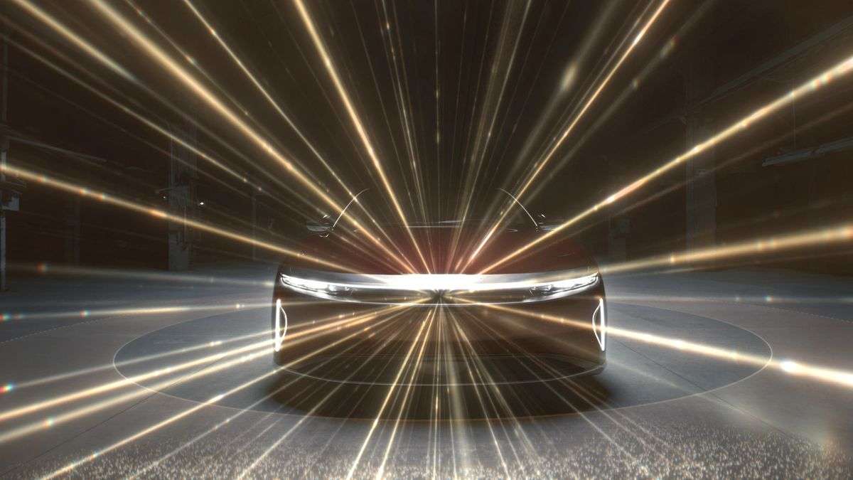 Image of the front of a Lucid Air with gold beams shooting out from the center of its fascia representing its LIDAR system for driver assists.