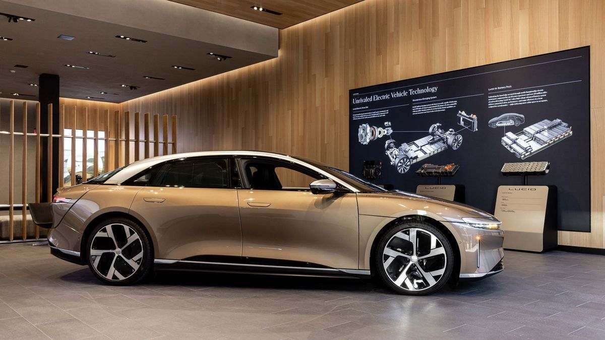 Image of a gold Lucid Air parked inside the brand's Newport Studio