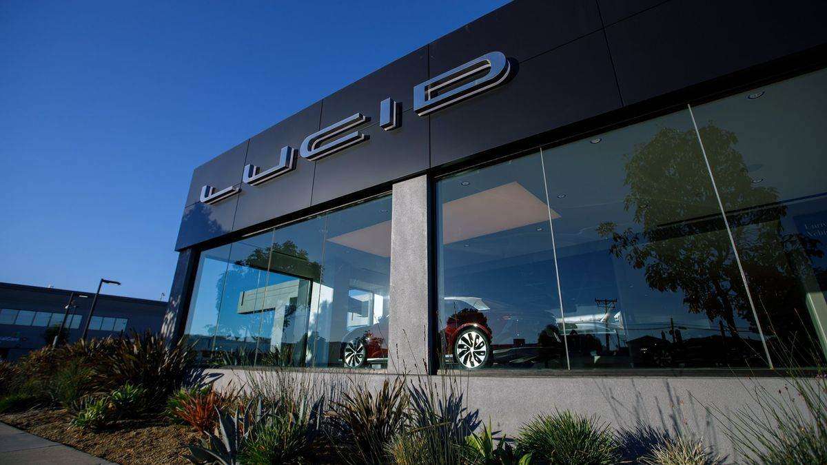 Image showing the exterior of a Lucid Studio featuring large glass walls displaying a Lucid Air sedan inside.