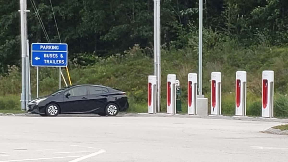 Image of Toyota Prius parked next to a Supercharger by John Goreham