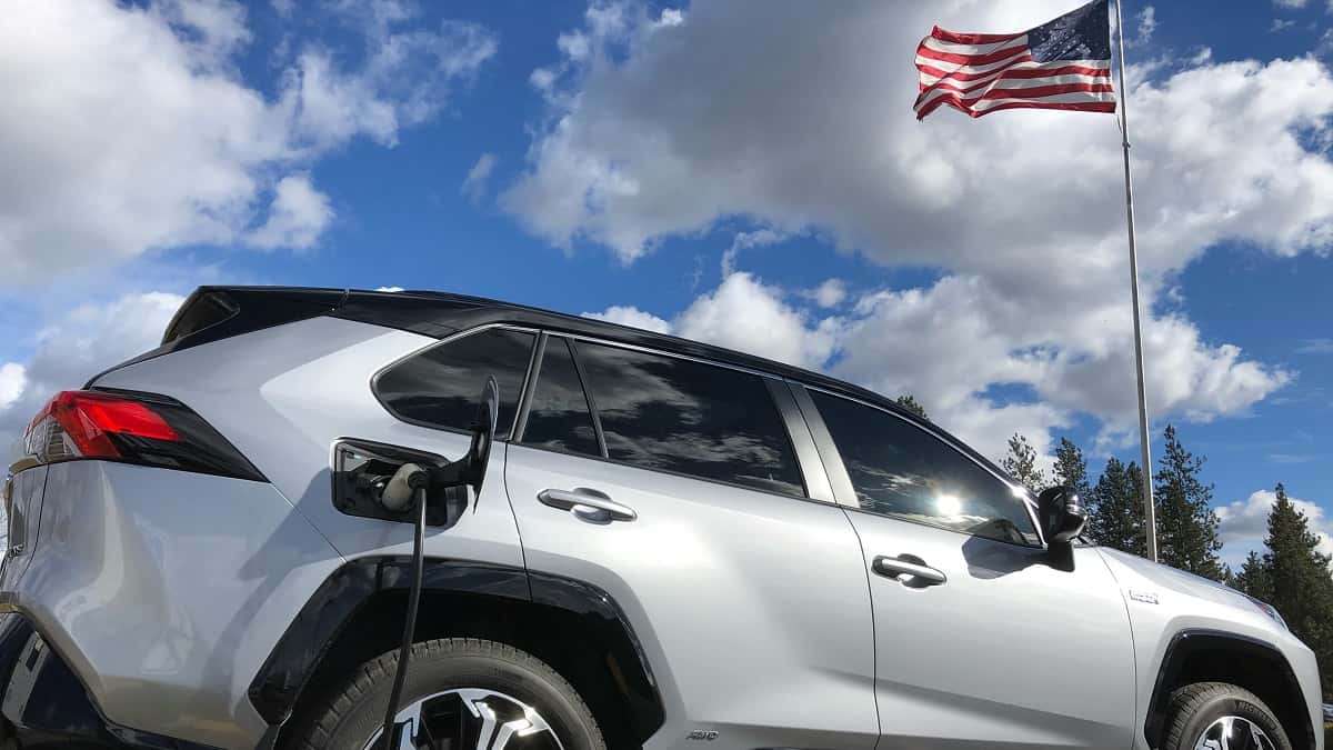 Image of Toyota RAV4 Prime and American flag by Kate Silbaugh