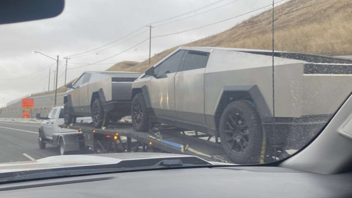 Two Tesla Cybertrucks being towed on California road