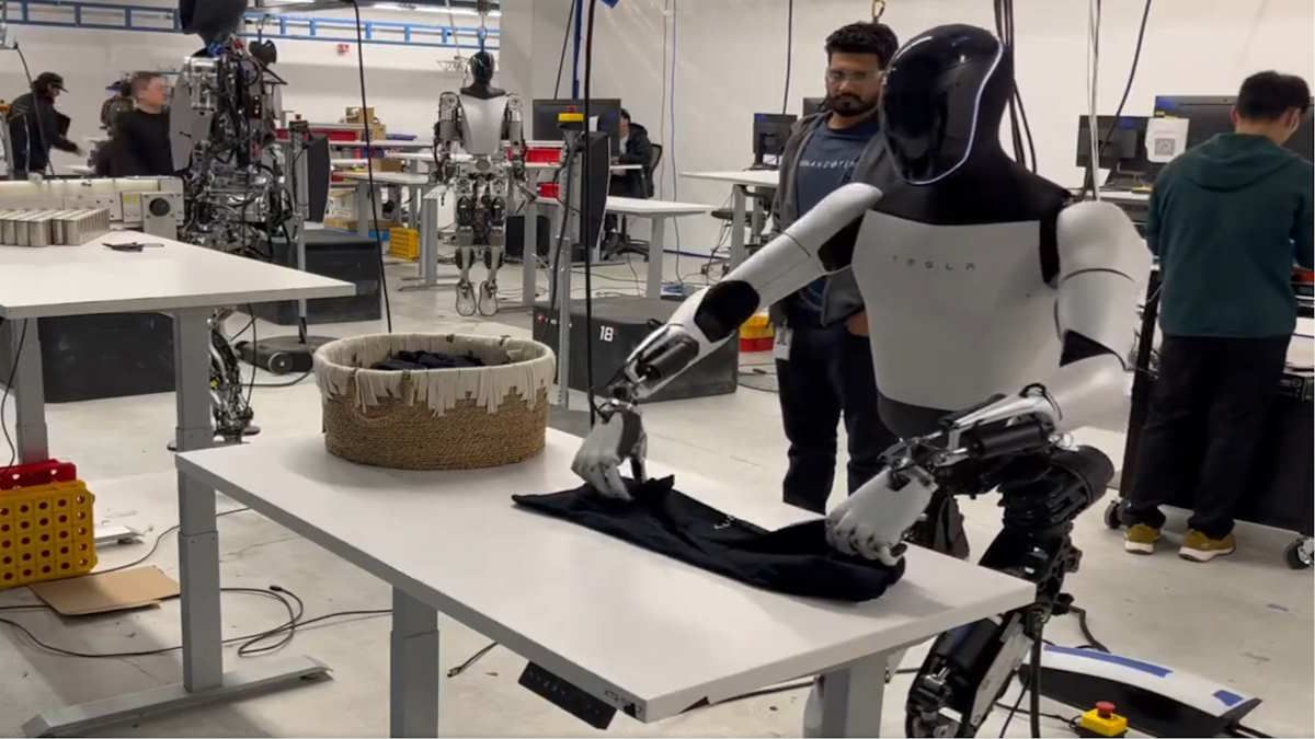 "Optimus Folds a Shirt" - Tesla Humanoid Robot Seen Folding Shirt In Factory Demonstration