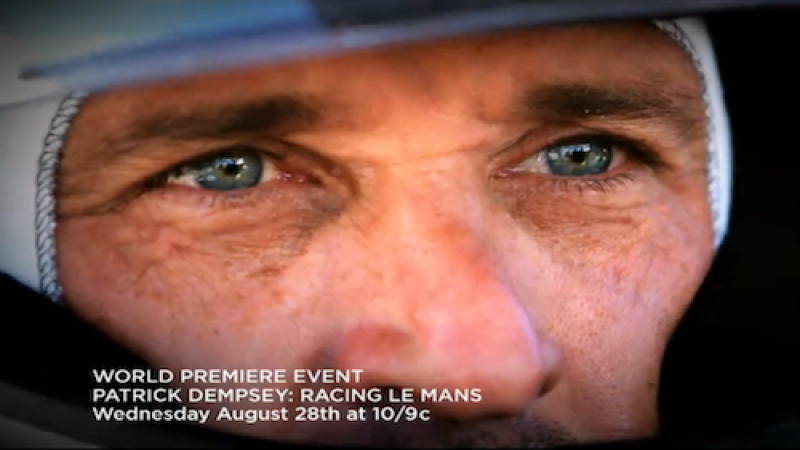 Patrick Dempsey driving a race car.