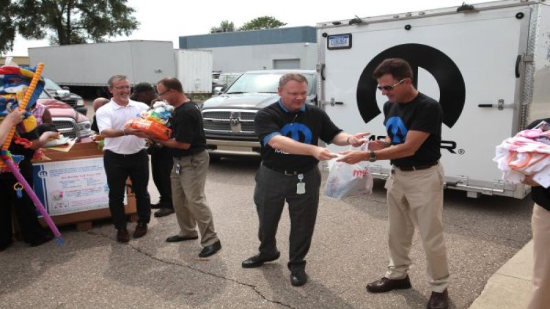 Mopar employees delivering baby goods