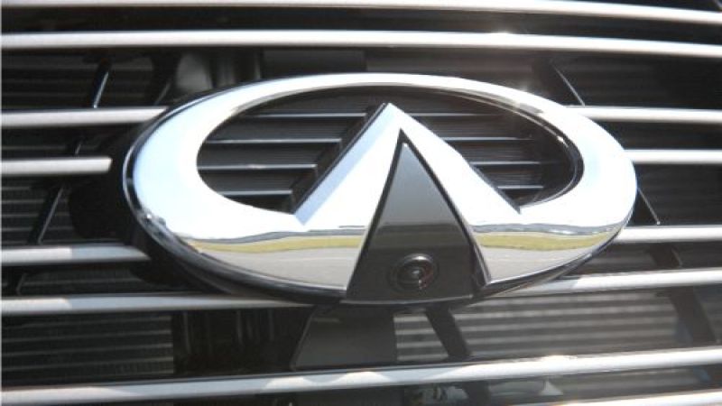 This image of an Infiniti logo shows the camera/sensor at the bottom of the oval