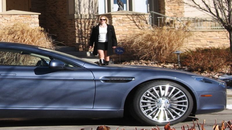 Katie MacKenzie approaching the 2011 Aston Martin Rapide Image © 2013 Don Bain