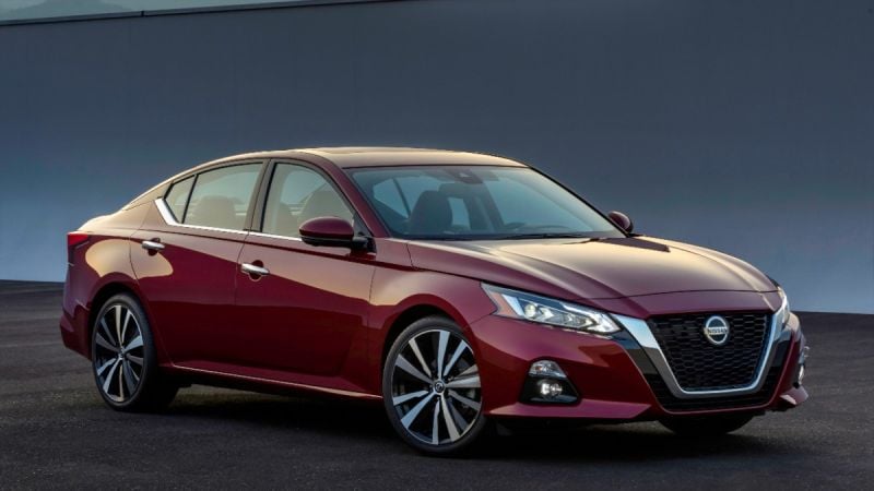 Deep red 2019 Nissan Altima sedan, angled front view with sleek profile against dark gray background