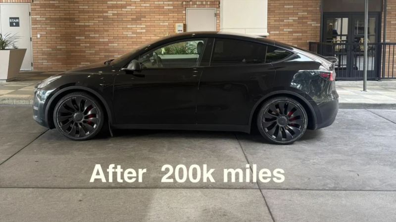 2022 Tesla Model Y, black, side view, featuring distinctive wheels and a clean exterior after 200,000 miles.