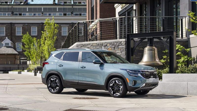 Light blue 2024 Kia Seltos in front of building