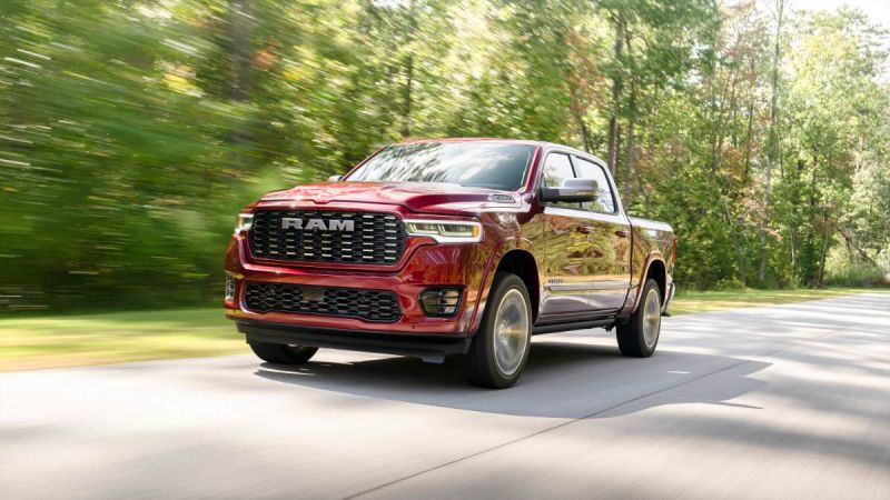 Candy apple red RAM pickup truck speeding down a tree-lined road with motion blur and gleaming chrome details
