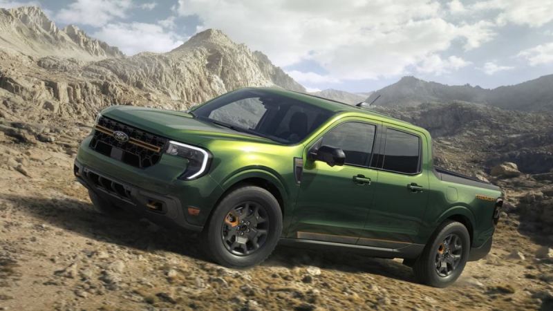 2024 Ford Maverick Tremor in metallic green, shown at three-quarter front angle climbing rocky mountain terrain, featuring off-road wheels and rugged styling.