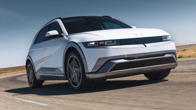 White 2025 Hyundai Ioniq 5 electric SUV turning on a desert road with angular, futuristic design