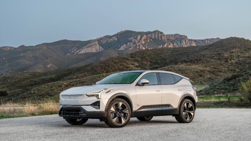 Pearl white Polestar 3 electric SUV parked on mountain road with rugged rocky landscape backdrop