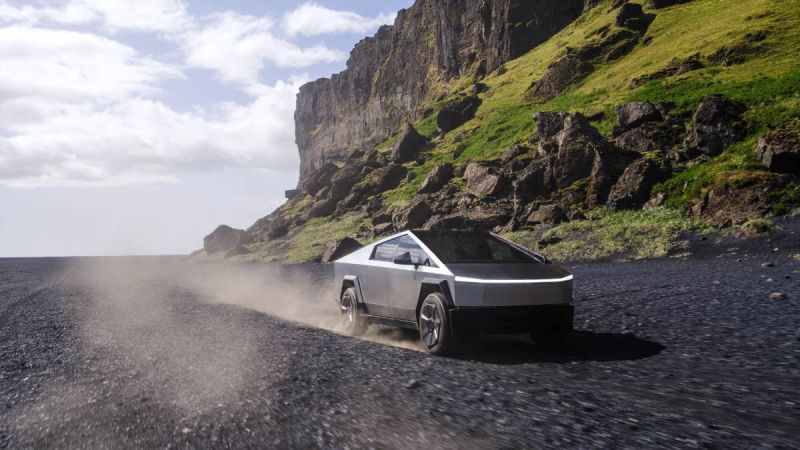 Stainless steel Tesla Cybertruck driving on rocky volcanic terrain, kicking up dust with steep cliff backdrop