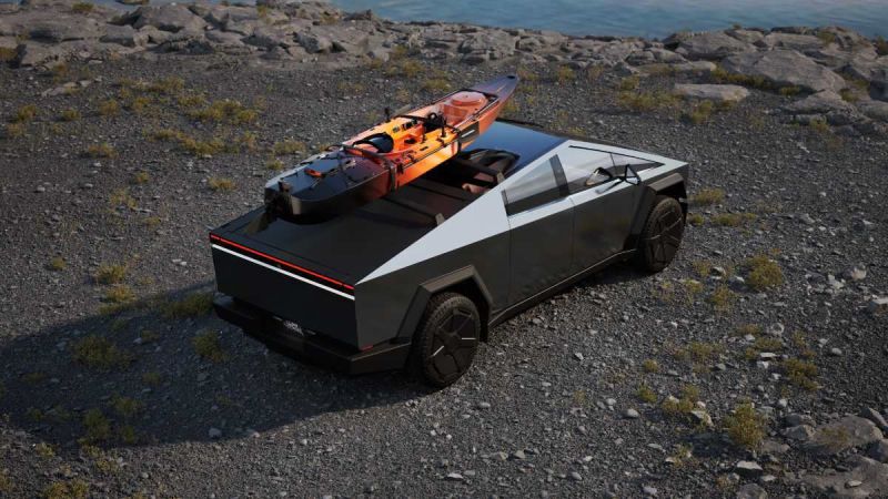 A black and silver futuristic vehicle parked on rocky terrain, with a kayak secured on top, beside a tranquil water scene.