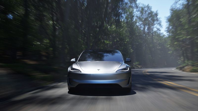 Silver Tesla sedan driving through misty forest road with blurred trees and motion blur effect