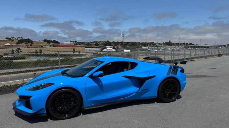 Blue 2025 Chevrolet Corvette C8 shown from front three-quarter angle on a racetrack.