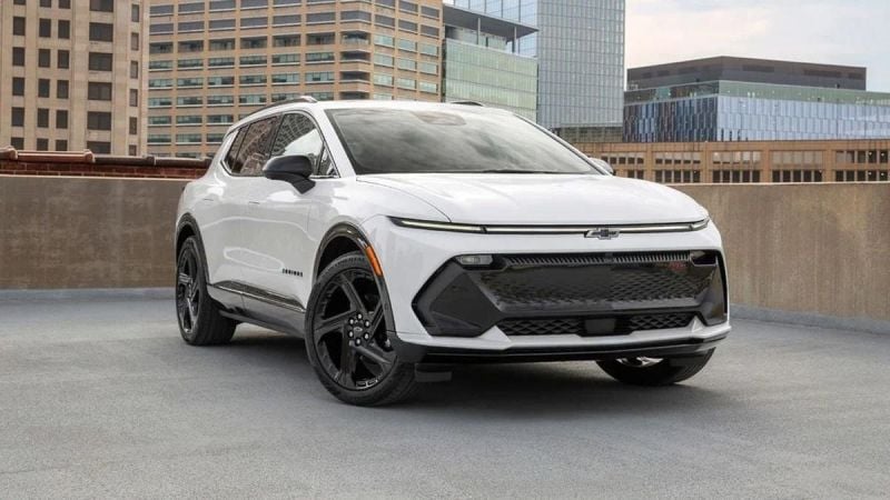 White 2025 Chevrolet Equinox EV RS on urban rooftop parking with city skyline