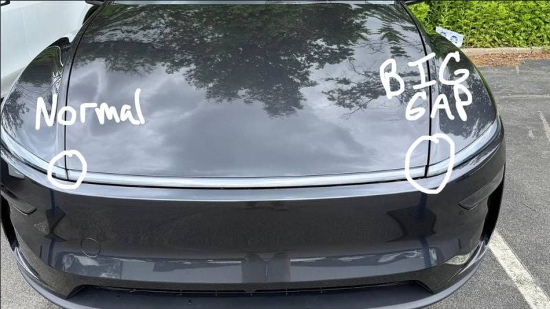 A black 2026 Tesla Model Y Juniper hood, labeled "Normal" on one side and "BIG GAP" on the other, highlighting a noticeable gap in the body alignment.