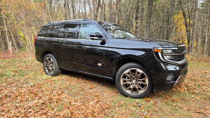 A 2026 Ford Expedition King ranch sits majestically in front of a fall foliage scene.