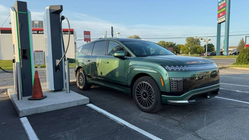 Sage green 2026 Hyundai Ioniq 9 SUV charging at electric station, sleek multi-spoke wheels, modern design