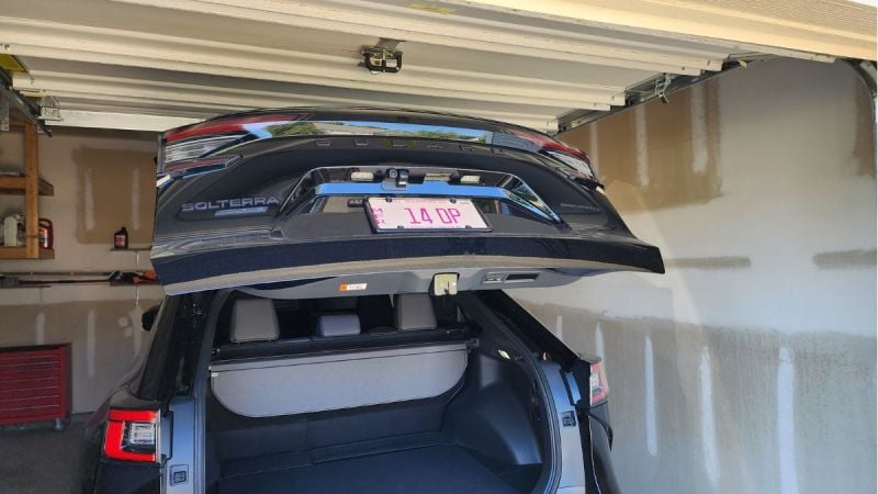 2026 Subaru Solterra inside a garage and the trunk opened hitting the uper part of the garage door