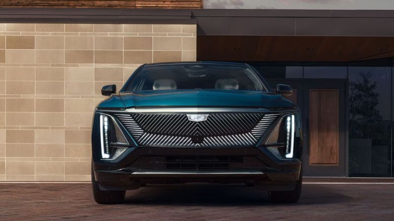 2026 Cadillac Lyriq in green, front view showcasing distinctive grille and LED headlights.